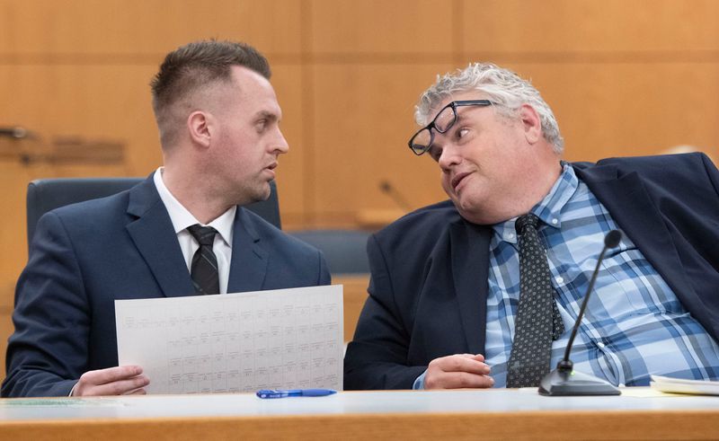 Jesse LaCoste and his attorney, Todd Early, review a copy of the criminal complaint against him during the jury selection process on Oct. 13, 2025. LaCoste is charged with racketeering and organized fraud.