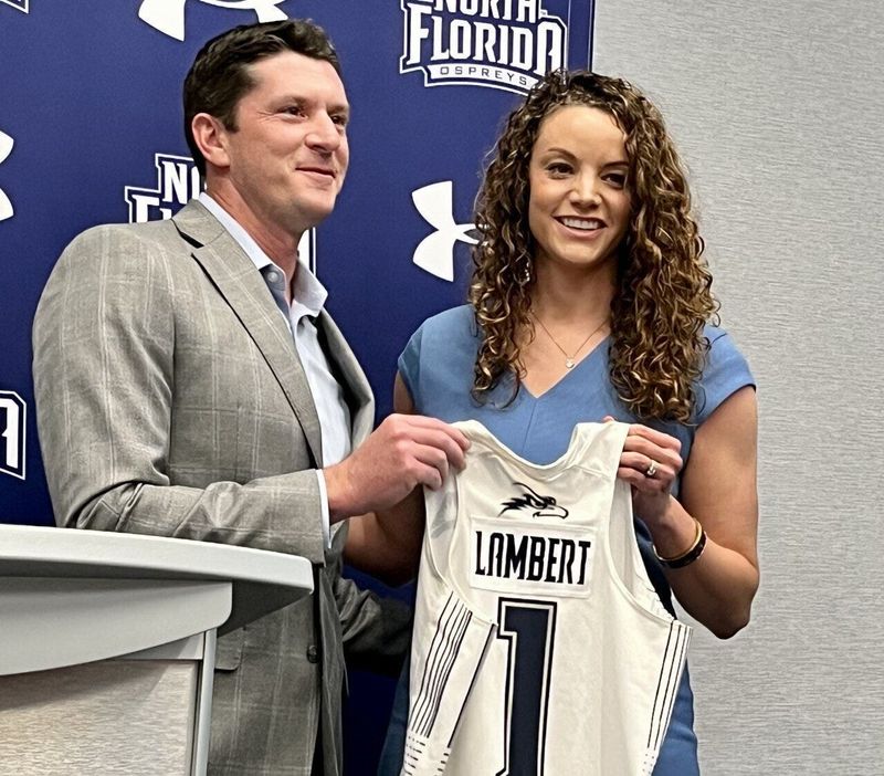Nick Morrow (left) welcomes Erika Lambert as the University of North Florida women's basketball coach on April 21, 2023.