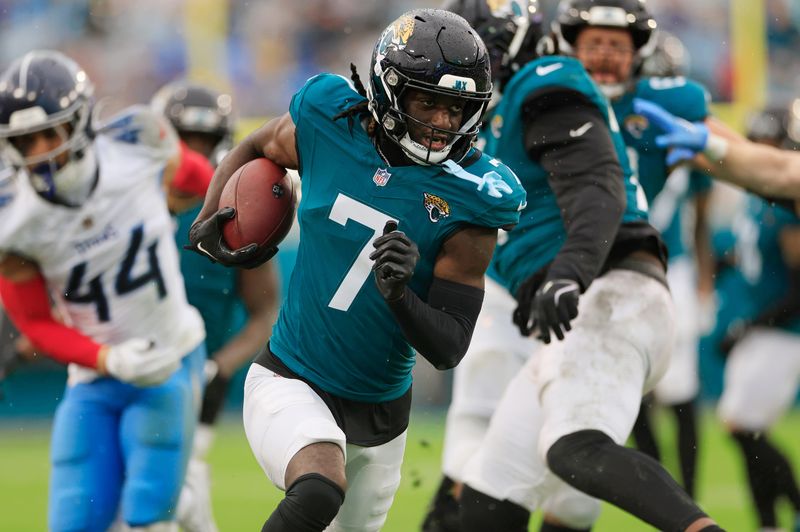 Jacksonville Jaguars wide receiver Brian Thomas Jr. (7) rushes for yards during the second quarter of an NFL football matchup Sunday, Dec. 29, 2024 at EverBank Stadium in Jacksonville, Fla. The Jaguars held off the Titans 20-13. [Corey Perrine/Florida Times-Union]