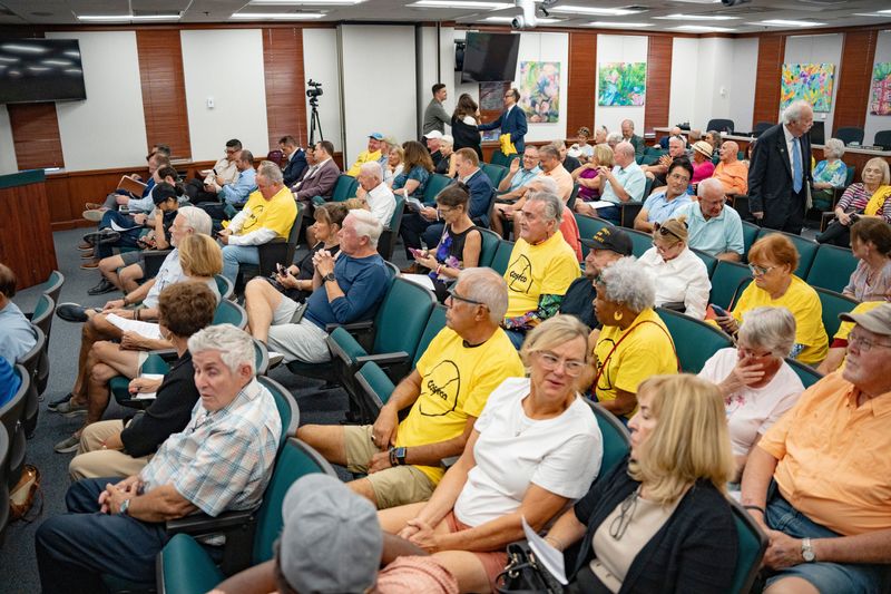 Dozens of people gather to oppose the new Costco during a county commission hearing on the plans at the Collier County Government Center in Naples, Fla., on Tuesday, Oct. 14, 2025. Many wore yellow shirts that had "Costco" crossed out.