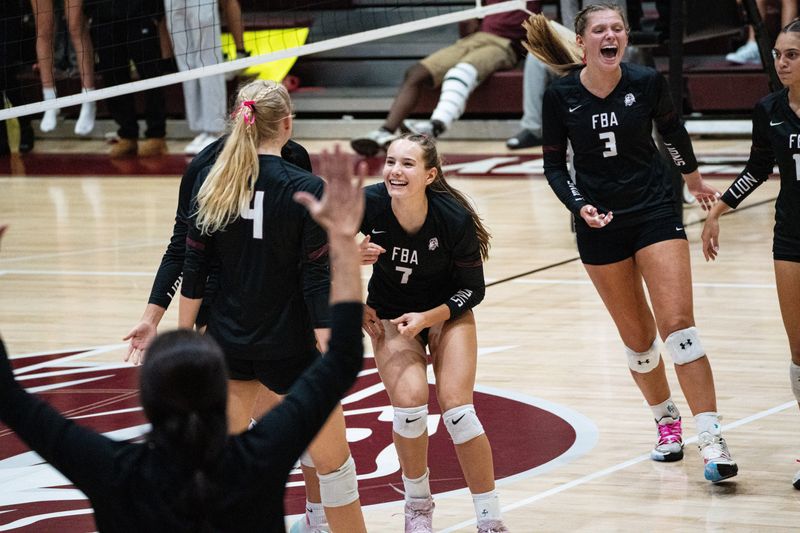 Members of the First Baptist Academy volleyball team celebrate a point over Marco Island Academy at FBA during the Class 2A-District 9 title game on Thursday, Oct. 16, 2025. FBA won 3-0.