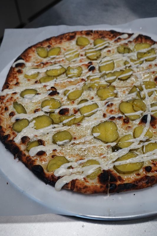 Bucks Coal Fired serves its pickle pizza with dill aioli.