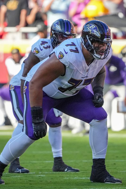 Sep 28, 2025; Kansas City, Missouri, USA; Baltimore Ravens guard Daniel Faalele (77) at the line of scrimmage against the Kansas City Chiefs during the game at GEHA Field at Arrowhead Stadium. Mandatory Credit: Denny Medley-Imagn Images