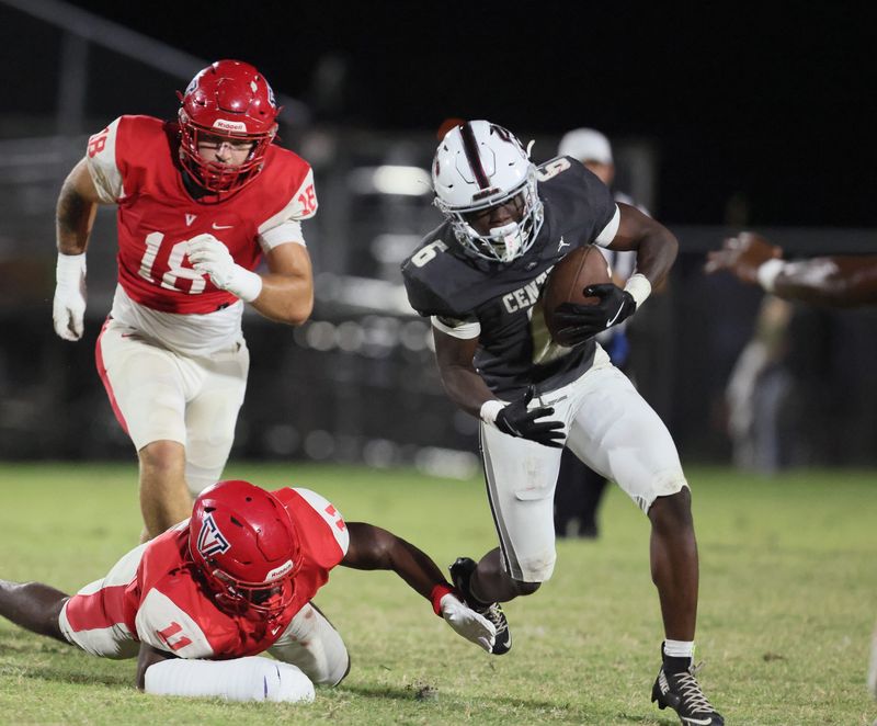 Palm Beach Central running back Andrew Ulysse (6) evades Vanguard Kelvin Pinkney Jr. (11) during an FHSAA football game at Booster Stadium in Ocala, FL on Friday, October 17, 2025. [Alan Youngblood/Ocala Star-Banner]