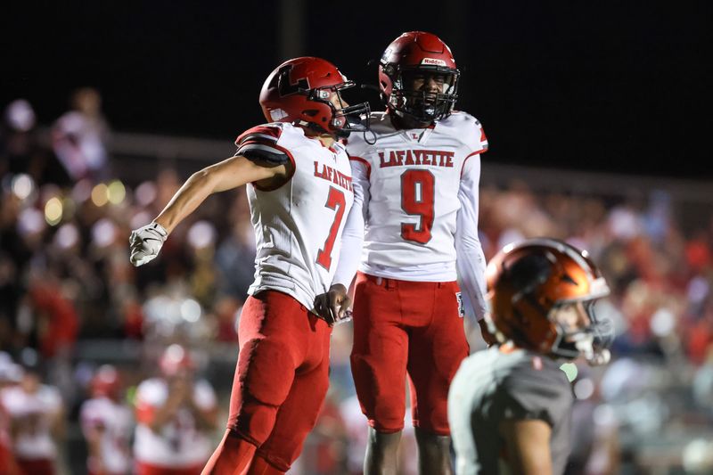 Lafayette Hornets player Lane O'Steen (7) and Lafayette Hornets player Tywan K Williamson (9) celebrate after a touchdown during the first half of a football game between Lafayette High School and Trenton High School at Trenton High School in Trenton, FL on Friday, October 17, 2025. [Chris Watkins/Gainesville Sun]