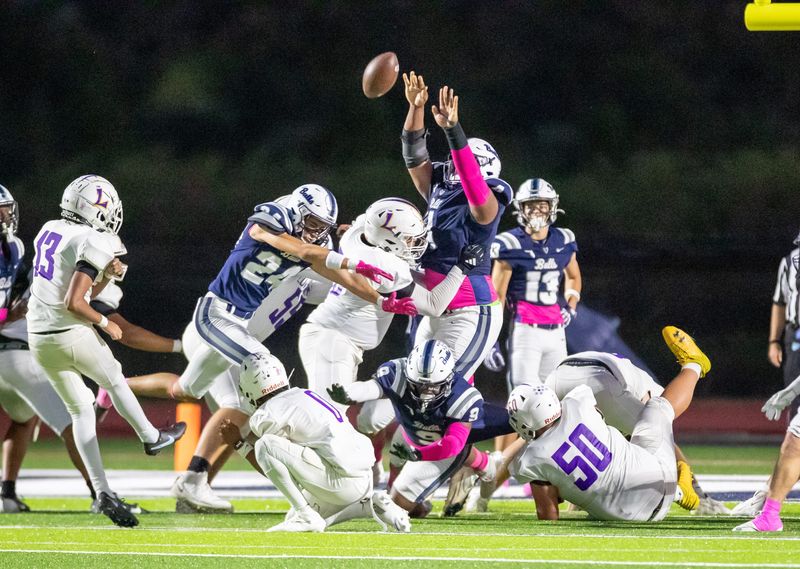 Parrish Community defeated Lennard 14-6 in a high school football game on Friday, Oct. 17, 2025. Kaleb Exume (4) of Parrish rises up to block an extra-point attempt by Lennard's Zail Lateef (13).