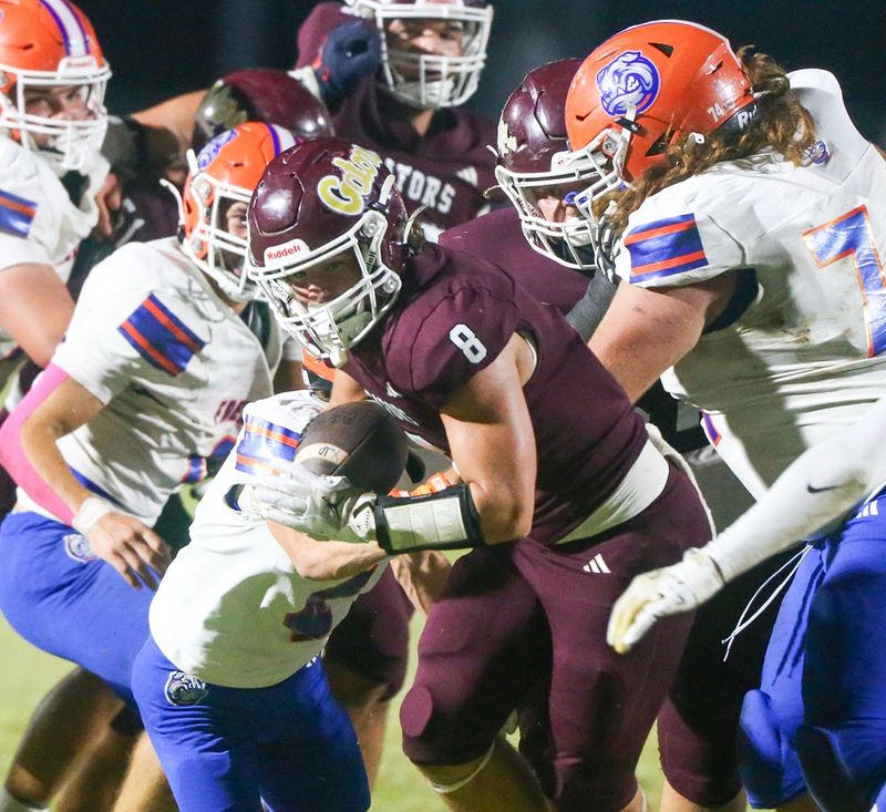 Baker RB Wyatt Straight breaks through the defense during the Baker Freeport football game at Baker.