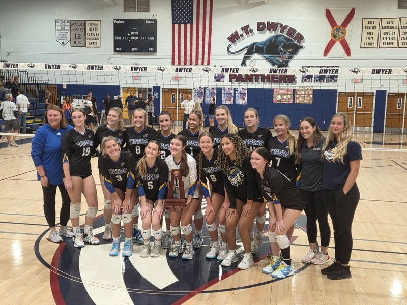 The Martin County High School volleyball team poses for pictures after winning the District 8-6A title with a four-set victory over Dwyer on Thursday, Oct. 16, 2025 from W.T. Dywer High School in Palm Beach Gardens.