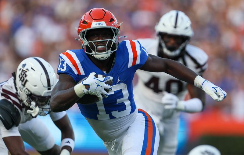Florida running back Jadan Baugh (13) scores against the Mississippi State during the first half of an NCAA football game at Steve Spurrier Field at Ben Hill Griffin Stadium in Gainesville, FL on Saturday, October 18, 2025. [Alan Youngblood/Gainesville Sun]