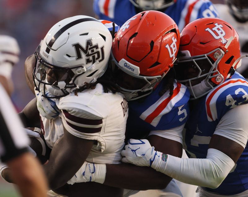 Florida linebacker Myles Graham (5) and Florida defensive back Alfonzo Allen Jr. (43) shut down Mississippi State running back Davon Booth (6) during the second half an NCAA football game at Steve Spurrier Field at Ben Hill Griffin Stadium in Gainesville, FL on Saturday, October 18, 2025. [Alan Youngblood/Gainesville Sun]