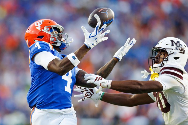 Oct 18, 2025; Gainesville, Florida, USA; Florida Gators wide receiver TJ Abrams (4) makes a catch over Mississippi State Bulldogs cornerback Jett Jefferson (20) during the second half at Ben Hill Griffin Stadium. Mandatory Credit: Matt Pendleton-Imagn Images