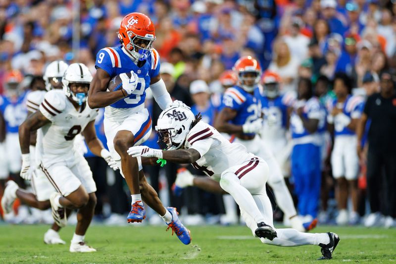 Oct 18, 2025; Gainesville, Florida, USA; Florida Gators wide receiver J. Michael Sturdivant (9) breaks a tackle from Mississippi State Bulldogs cornerback Deago Brumfield (4) during the second half at Ben Hill Griffin Stadium. Mandatory Credit: Matt Pendleton-Imagn Images
