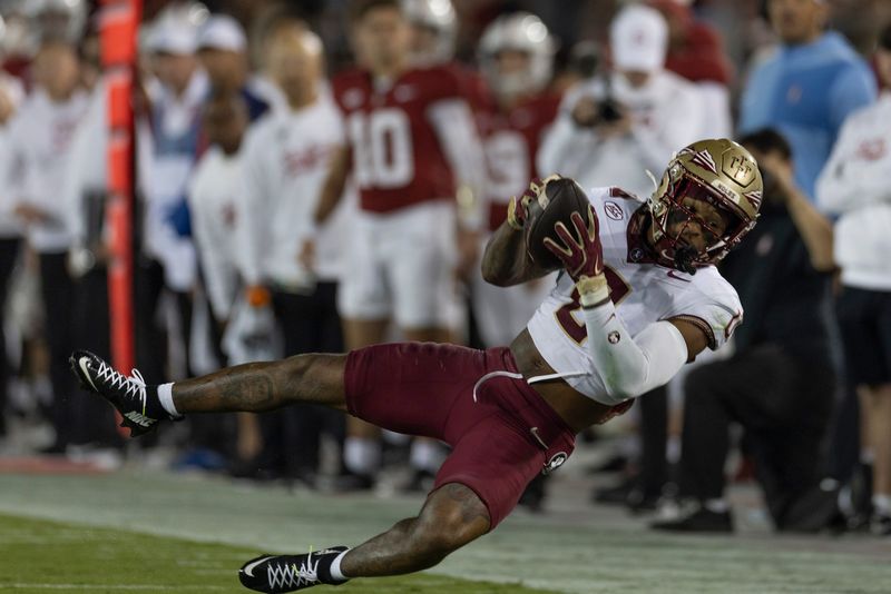 Oct 18, 2025; Stanford, California, USA; Florida State Seminoles defensive back Earl Little Jr. (0) intercepts the ball during the first quarter against the Stanford Cardinal at Stanford Stadium. Mandatory Credit: Stan Szeto-Imagn Images
