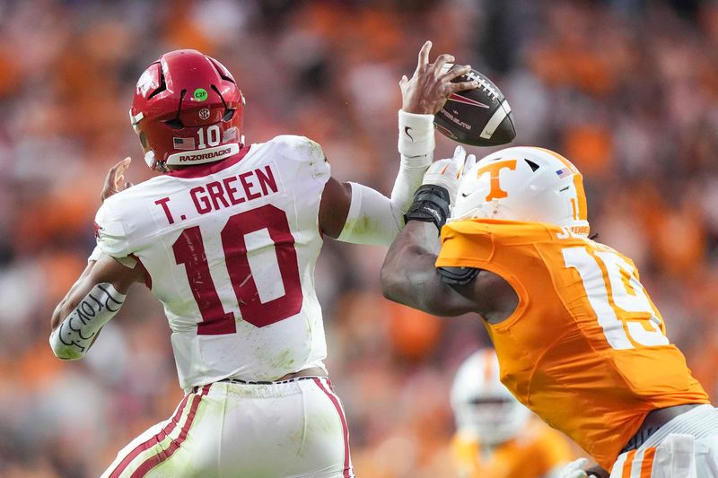 Tennessee defensive lineman Joshua Josephs (19) causes Arkansas quarterback Taylen Green (10) to drop the ball for a fumble during a college football game between Tennessee and Arkansas at Neyland Stadium in Knoxville, Tenn., on Oct. 11, 2025.