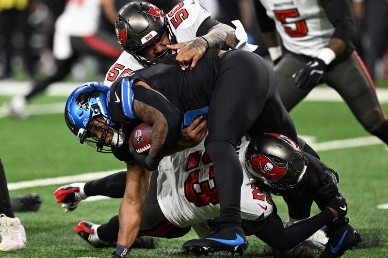 Oct 20, 2025; Detroit, Michigan, USA; Detroit Lions running back David Montgomery (5) rushes the ball against Tampa Bay Buccaneers defensive tackle Vita Vea (50) during the first half at Ford Field. Mandatory Credit: Lon Horwedel-Imagn Images