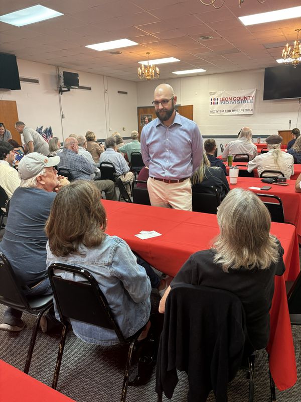 Nic Zateslo, a Democratic candidate for the 2nd Congressional District talks to townhall attendees before the meeting, Oct. 20, 2025