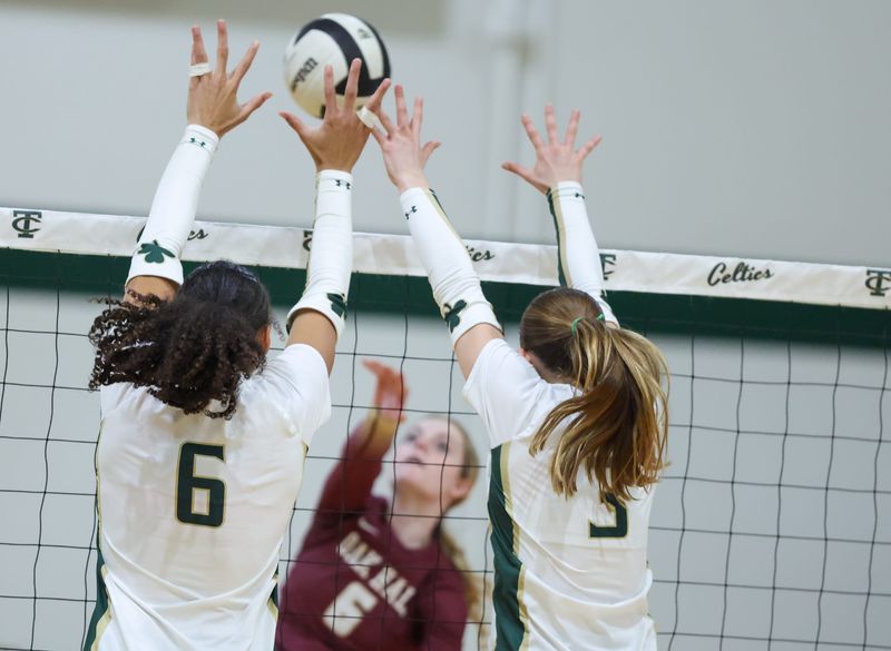 Trinity Catholic middle blocker Addyson Avery (6) and Trinity Catholic setter Margaret O'Farrell (3) try to block Oak Hall Hannah Timm (6) during the FHSAA Class 2A-Region 1 volleyball Quarterfinal at Trinity Catholic in Ocala, FL on Tuesday, October 21, 2025. [Alan Youngblood/Gainesville Sun]