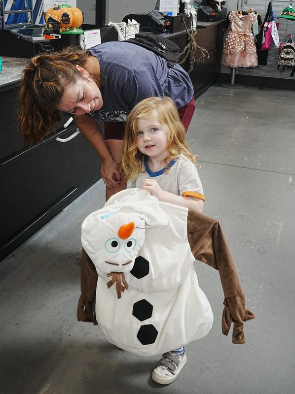Molly King and her 2-year-old daughter Dylan, shop for Halloween costumes at Goodwill in Viera, where Dylan found this outfit and can now dress as Olaf from "Frozen." Thrift stores offer an alternative for a Halloween on a budget, with costumes, lawn and home decor and more.