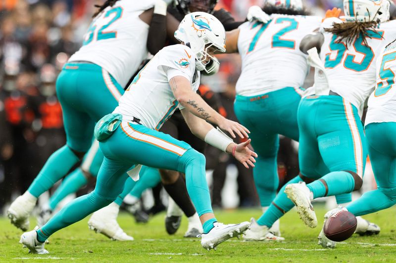 Oct 19, 2025; Cleveland, Ohio, USA; Miami Dolphins quarterback Quinn Ewers (14) fumbles the ball against the Cleveland Browns during the fourth quarter at Huntington Bank Field. Mandatory Credit: Scott Galvin-Imagn Images