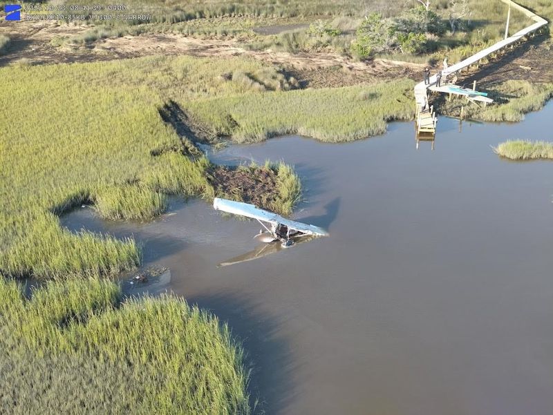 This aerial photo shows the crash path of a plane piloted by a 20-year-student into Redfish Creek north of the Northeast Florida Regional Airport in St. Augustine and the dock and kayak used by St. Johns County first responders.