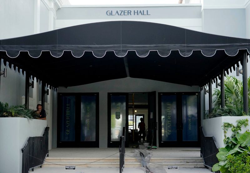 Glazer Hall in Palm Beach has awnings with signage that was historically part of the building and did not require a variance. An ordinance approved on first reading by the Town Council allows other businesses to seek design approval instead of a variance.