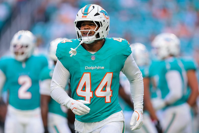 Aug 23, 2025; Miami Gardens, Florida, USA; Miami Dolphins linebacker Chop Robinson (44) reacts after sacking Jacksonville Jaguars quarterback John Wolford (not pictured) during the first quarter at Hard Rock Stadium. Mandatory Credit: Sam Navarro-Imagn Images