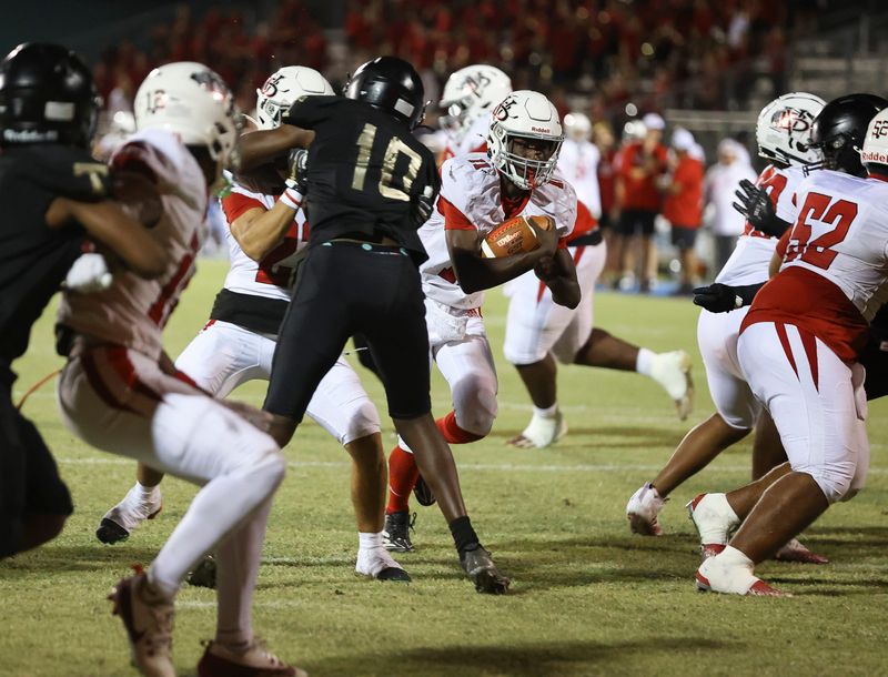 Vero Beach quarterback Efrem White (11) finds an opening during a high school football game against Treasure Coast, Oct. 24, 2025, at South County Regional Stadium in Port St. Lucie.