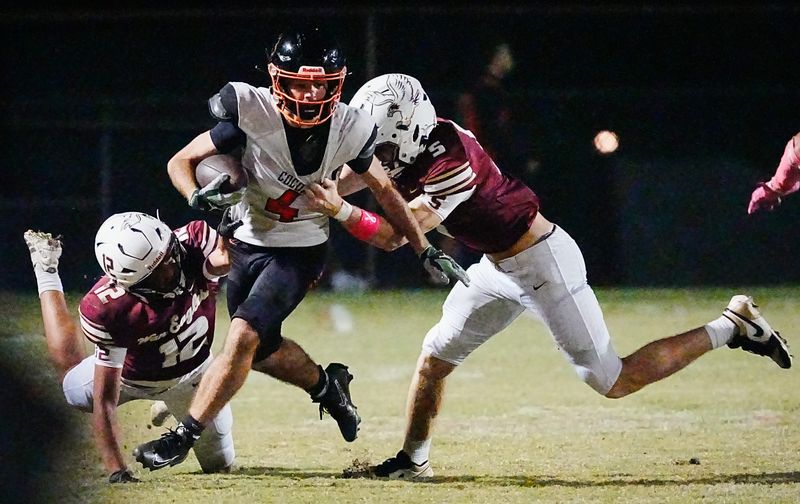 Troy Silberzahn of Cocoa is tackled by Brennan Waldrop and Riley Florence of Astronaut during their game October 24, 2025. Craig Bailey, FLORIDA TODAY via USA TODAY NETWORK