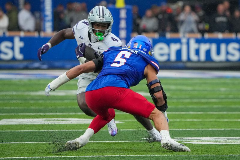 Kansas Jayhawks defensive end Dean Miller (5) goes for a tackle against Kansas State in 2025.