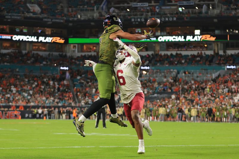 Miami Hurricanes wide receiver CJ Daniels (7) catches the football for a touchdown against Stanford Cardinal cornerback Jay Green (5) during the second quarter Oct. 25, 2025 at Hard Rock Stadium in Miami Gardens, Florida. Mandatory Credit: Sam Navarro-Imagn Images
