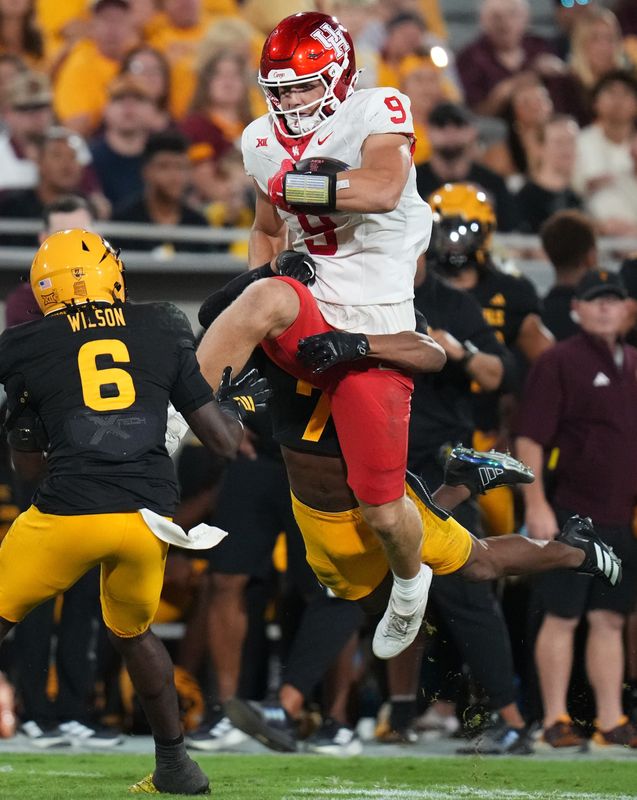 ASU defensive back Montana Warren (7) grabs leaping Houston Cougars tight end Tanner Koziol (9) at Mountain America Stadium in Tempe on Oct. 25, 2025.