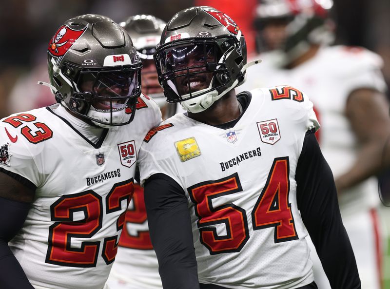 Oct 26, 2025; New Orleans, Louisiana, USA; Tampa Bay Buccaneers outside linebacker Lavonte David (54) and safety Tykee Smith (23) react after a tackle during the first quarter against the New Orleans Saints at Caesars Superdome. Mandatory Credit: Stephen Lew-Imagn Images