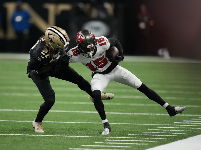 Oct 26, 2025; New Orleans, Louisiana, USA; Tampa Bay Buccaneers wide receiver Tez Johnson (15) is tackled by New Orleans Saints safety Justin Reid (21) during the first quarter at Caesars Superdome. Mandatory Credit: Matthew Hinton-Imagn Images
