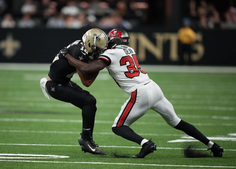 Oct 26, 2025; New Orleans, Louisiana, USA; New Orleans Saints wide receiver Chris Olave (12) is tackled by Tampa Bay Buccaneers cornerback Jamel Dean (35) during the fourth quarter at Caesars Superdome. Mandatory Credit: Matthew Hinton-Imagn Images