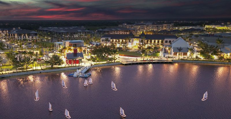An aerial view of the Downtown Wellen Park waterfront at night. Phase II of the commercial offerings at the Downtown Wellen master-planned town center will start opening in the spring and summer of 2026.