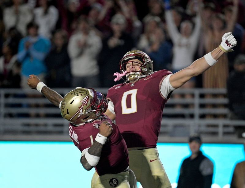 Nov 1, 2025; Tallahassee, Florida, USA; Florida State Seminoles quarterback Tommy Castellanos (1) celebrates a touchdown with wide receiver Duce Robinson (0) during the second half against the Wake Forest Demon Deacons at Doak S. Campbell Stadium. Mandatory Credit: Melina Myers-Imagn Images