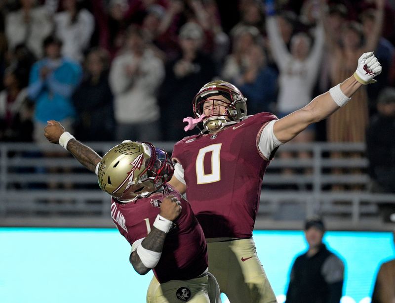 Nov 1, 2025; Tallahassee, Florida, USA; Florida State Seminoles quarterback Tommy Castellanos (1) celebrates a touchdown with wide receiver Duce Robinson (0) during the second half against the Wake Forest Demon Deacons at Doak S. Campbell Stadium. Mandatory Credit: Melina Myers-Imagn Images