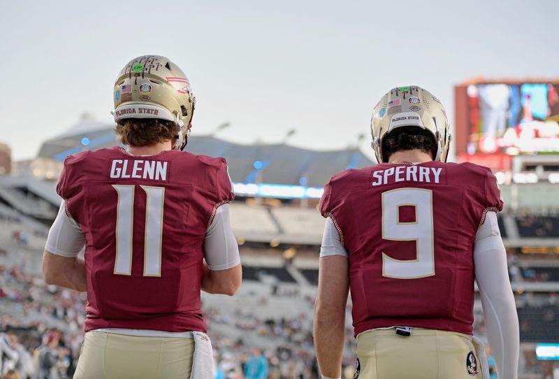 Nov 1, 2025; Tallahassee, Florida, USA; Florida State Seminoles quarterbacks Brock Glenn (11) (obscured) and Kevin Sperry (9) (obscured) warm up before the game against the Wake Forest Demon Deacons at Doak S. Campbell Stadium. Mandatory Credit: Melina Myers-Imagn Images