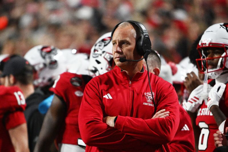 Nov 1, 2025; Raleigh, North Carolina, USA; NC State Wolfpack head coach Dave Doeren during the first quarter at Carter-Finley Stadium. Mandatory Credit: Zachary Taft-Imagn Images