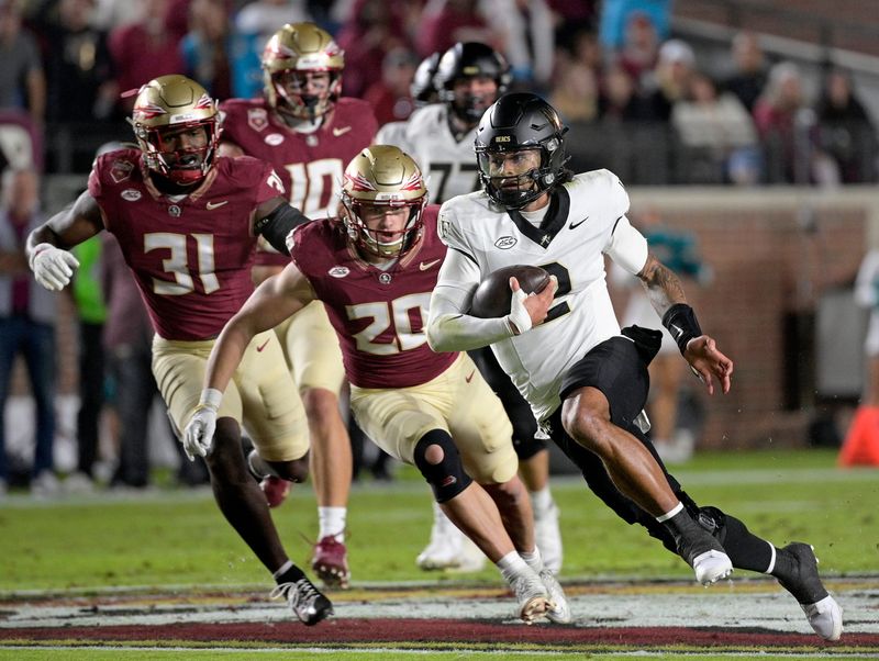 Nov 1, 2025; Tallahassee, Florida, USA; Wake Forest Demon Deacons quarterback Robby Ashford (2) runs the ball past Florida State Seminoles linebacker Blake Nichelson (20) during the first quarter at Doak S. Campbell Stadium. Mandatory Credit: Melina Myers-Imagn Images