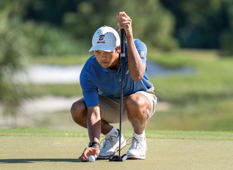 Benjamin School golfer Charlie Woods lines cup a putt during the Region 4-1A boys golf championship at The Park on November 3, 2025, in West Palm Beach, Florida.