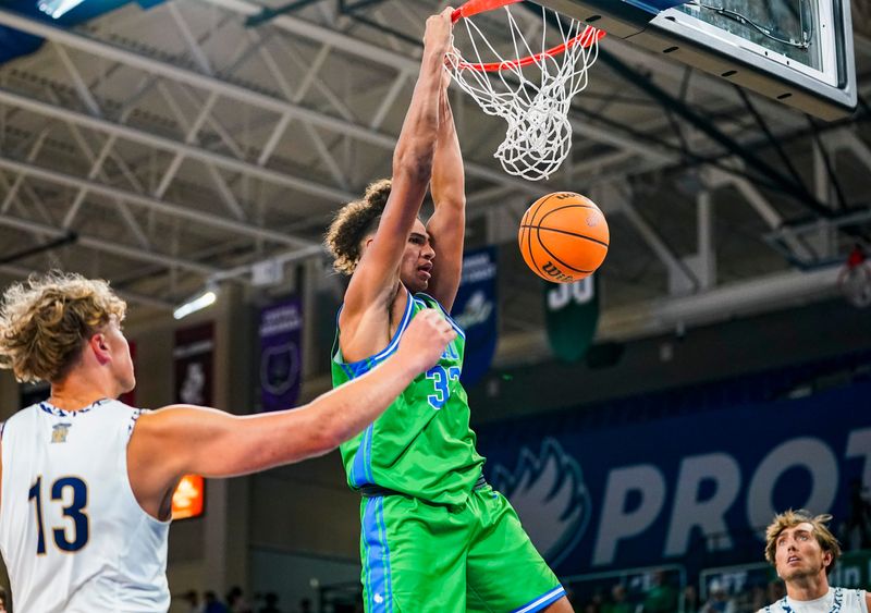 Florida Gulf Coast Eagles forward Isaiah Malone (32) dunks the ball during the first half of the season opener against the New College of Florida Mighty Banyans at Alico Arena in Fort Myers, Fla., on Monday, Nov. 3, 2025.