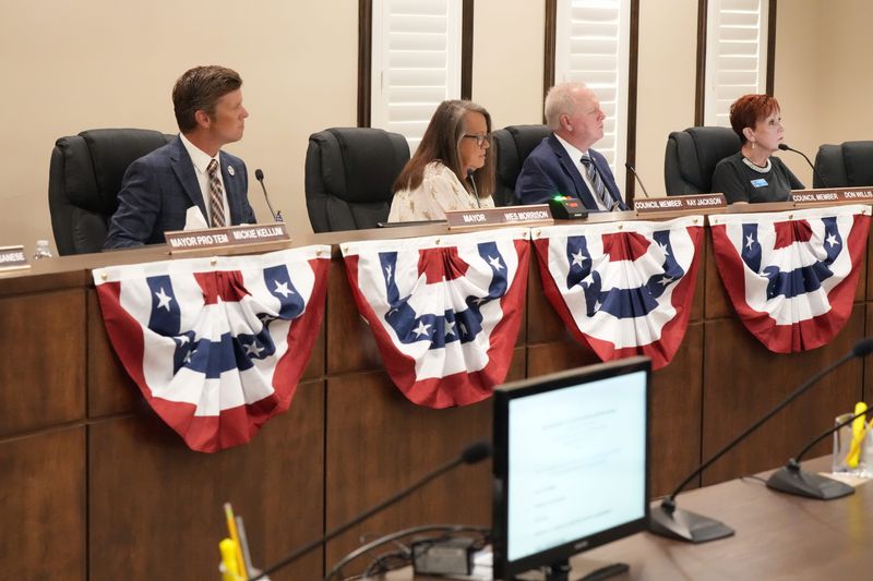 Cape Canaveral Mayor Wes Morrison and council members Kay Jackson, Don Willis and Kim Davis listen to speakers during a special city council meeting about the potential closure of Cape View Elementary School.