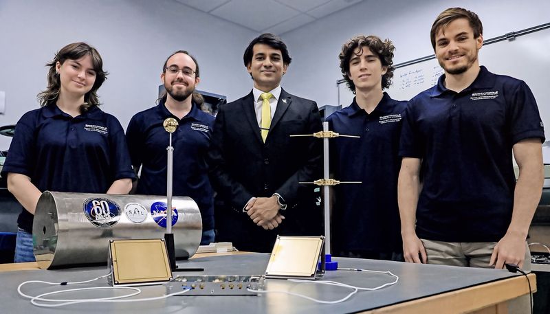 Embry-Riddle Aeronautical University's Space and Atmospheric Instrumentation Lab (SAIL) team members pose in front of devices they designed for NASA's ESCAPADE launch, possibly on Nov. 9, from Cape Canaveral to the atmosphere of Mars, at the Daytona Beach campus on Wednesday, Nov. 5, 2025. The team includes, from left, senior Skylar Wardlaw, research scientist Robert Clayton, professor and director Aroh Barjatya, PhD. candidate Nathan Graves and senior Ian Holland.