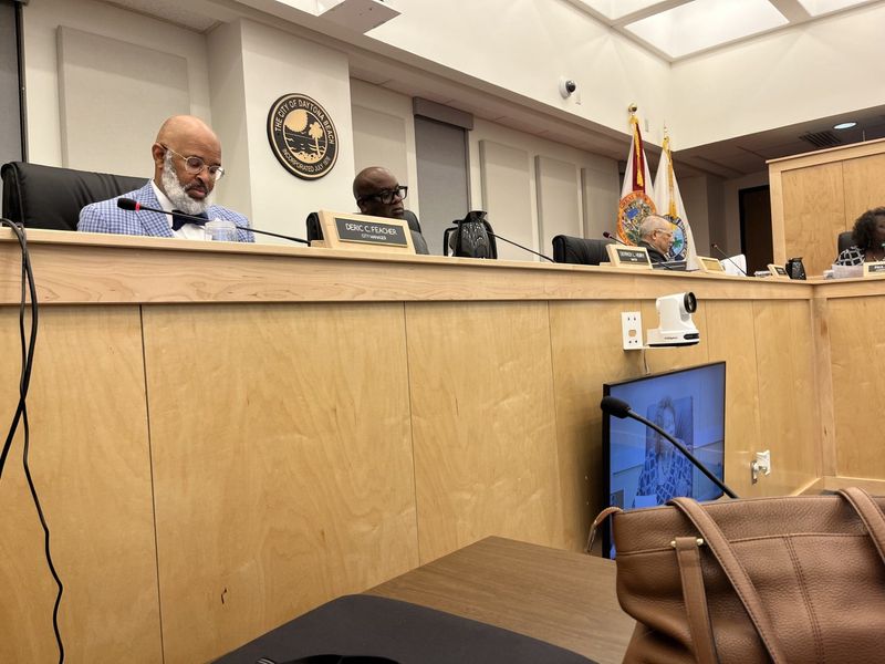 Daytona Beach City Manager Deric Feacher and Mayor Derrick Henry listened Nov. 5 as city commissioners discussed the city's use of payment cards for employees making smaller purchases that don't require city commissioner approvals.