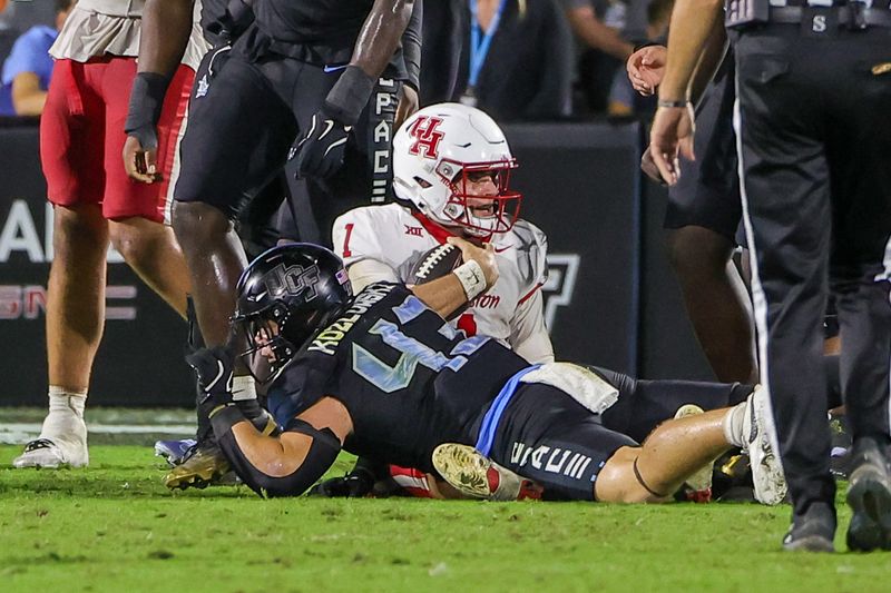 UCF linebacker Cole Kozlowski (43) tackles Houston quarterback Conner Weigman (1) on Nov. 7, 2025, at Acrisure Bounce House.