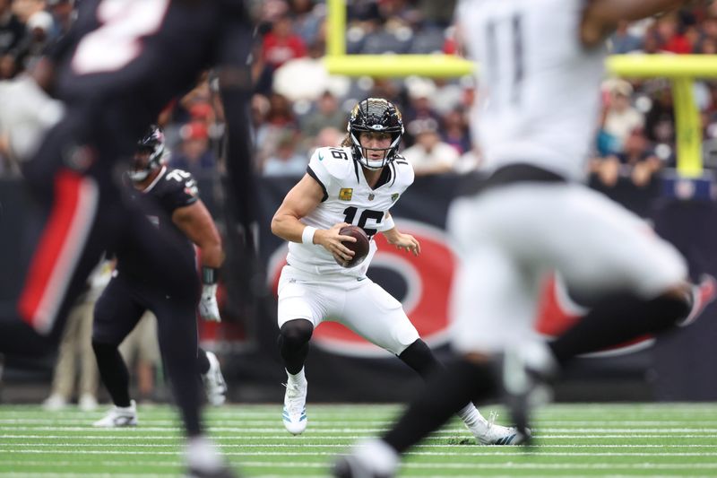 Nov 9, 2025; Houston, Texas, USA; Jacksonville Jaguars quarterback Trevor Lawrence (16) scrambles with the ball against the Houston Texans during the first half at NRG Stadium. Mandatory Credit: Troy Taormina-Imagn Images