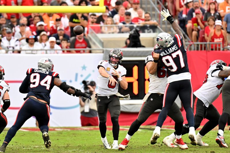 Nov 9, 2025; Tampa, Florida, USA; Tampa Bay Buccaneers quarterback Baker Mayfield (6) throws downfield during the fourth quarter against the New England Patriots at Raymond James Stadium. Mandatory Credit: Jonathan Dyer-Imagn Images