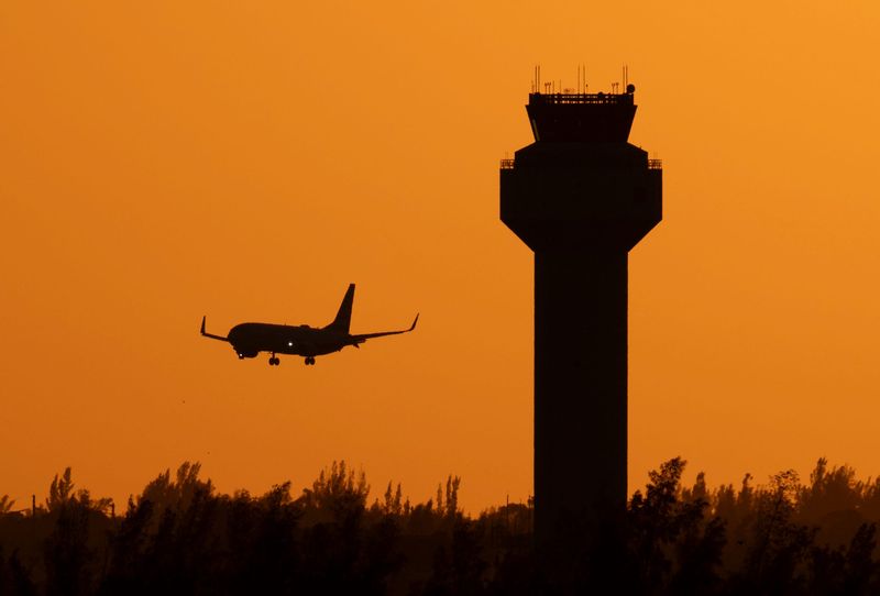 An American Airlines jet comes in for a landing at Palm Beach International Airport on November 9, 2025, in West Palm Beach, Florida. The airport experienced some delays and cancelled flights after the Trump administration ordered reductions to alleviate stress on air traffic controllers who are working without pay during the government shutdown.