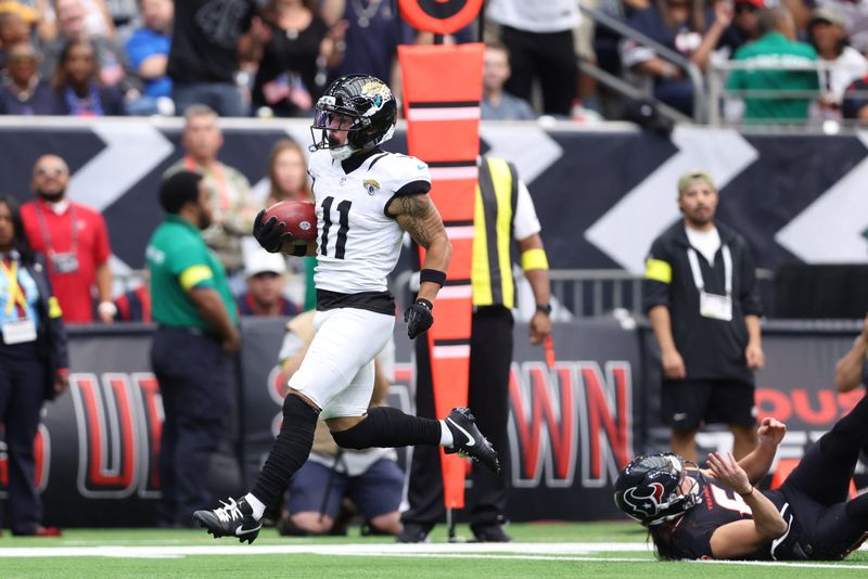 Nov 9, 2025; Houston, Texas, USA; Jacksonville Jaguars wide receiver Parker Washington (11) returns a punt for a touchdown against the Houston Texans during the first half at NRG Stadium. Mandatory Credit: Troy Taormina-Imagn Images